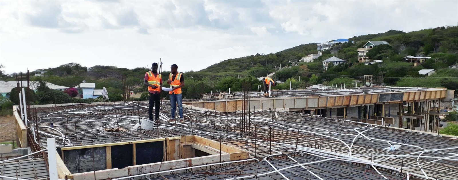 Alcopow engineers reviewing electrical plans on a construction site