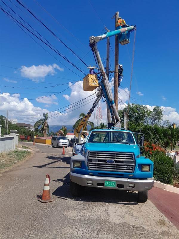 Alcopow bucket truck crew restoring power lines after Hurricane Melissa