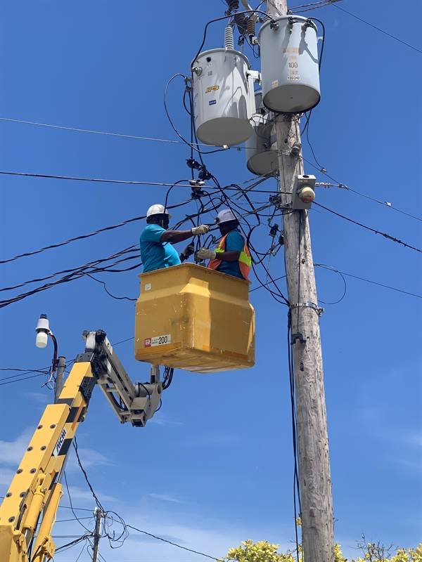 Bucket truck crew installing transformers at Oil Factory, Clarendon