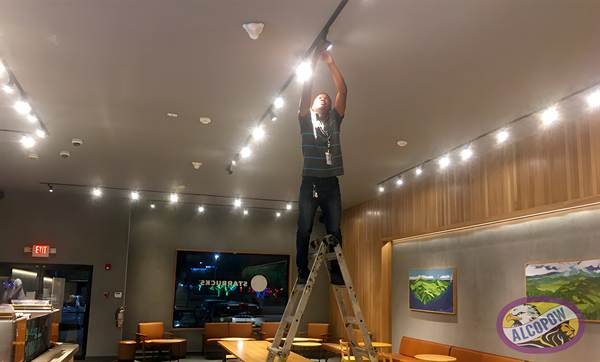 Electrician installing track lighting at Starbucks Montego Bay